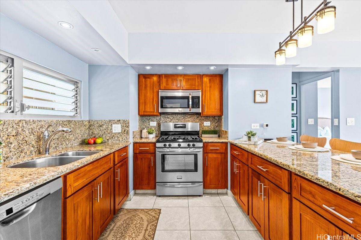 2161 Kalia Road, Unit 402 Honolulu, HI 96815 - Photo 8 of 25 a kitchen with stainless steel appliances granite countertop a stove a sink and a microwave