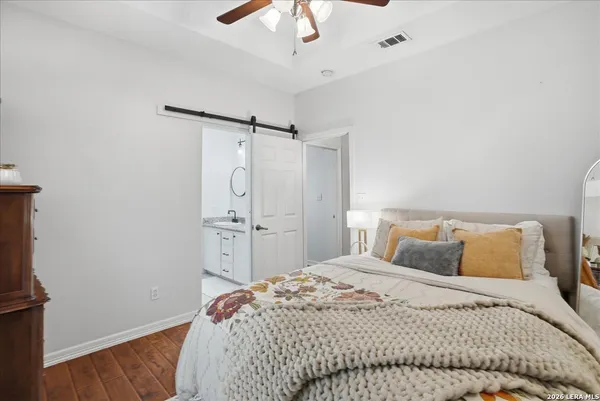 a bedroom with a bed and a chandelier