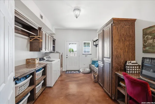 a utility room with sink dryer and washer