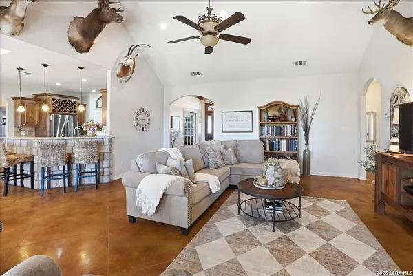 a living room with furniture a rug and a chandelier