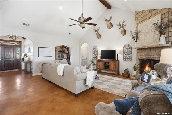 a living room with furniture a fireplace and a flat screen tv