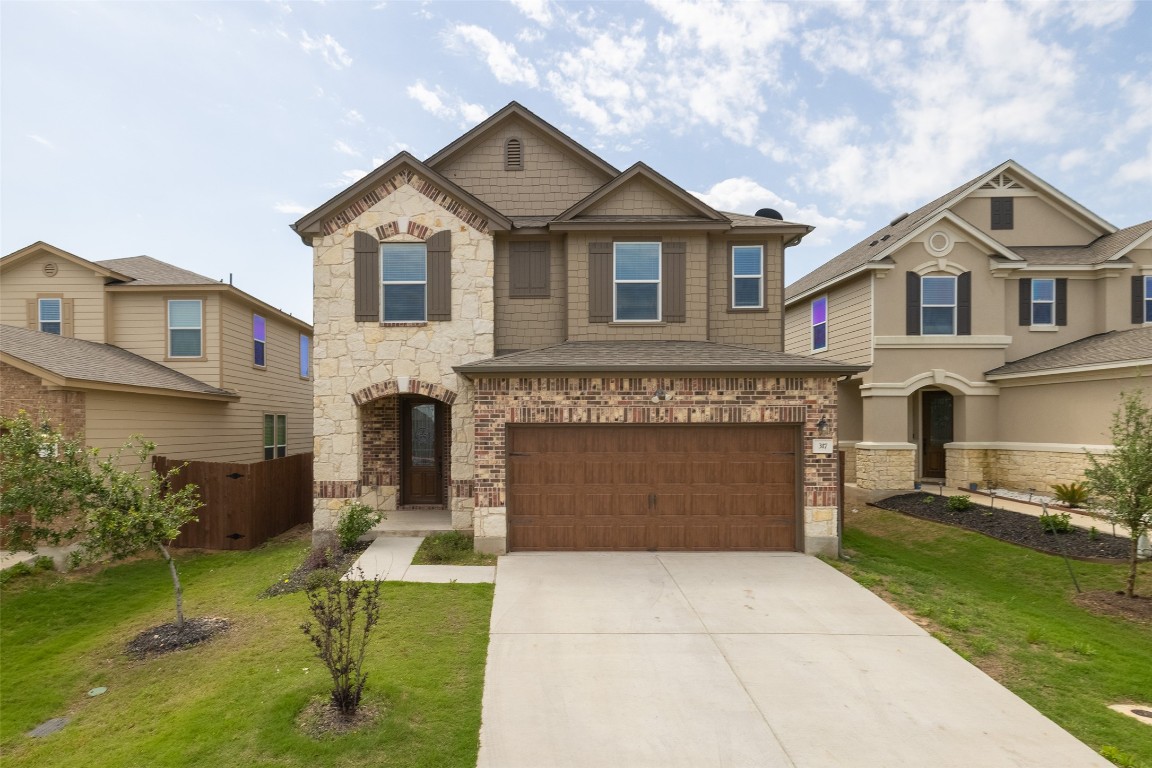 a front view of a house with a yard and garage