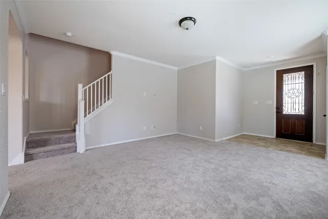 an empty room with windows and entrance