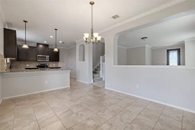 a view of a kitchen with a sink and refrigerator