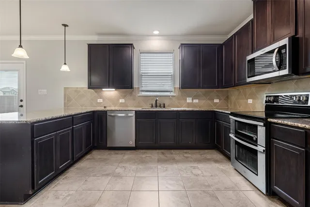 a kitchen with a sink stove and microwave