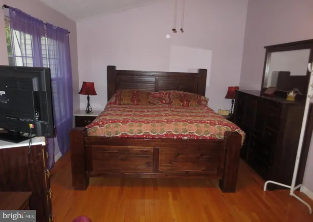 a bed room with a bed chair and a window