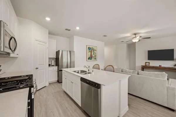 a kitchen with a sink stove and refrigerator