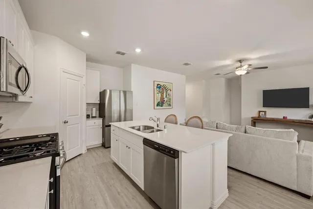 a kitchen with a sink stove and refrigerator