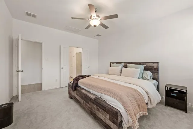 a bedroom with bed and a ceiling fan