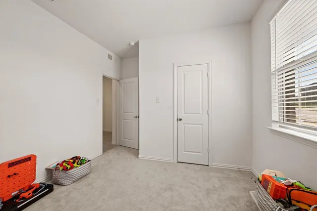 a livingroom with toys and dresser