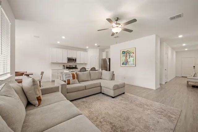 a living room with furniture and a chandelier