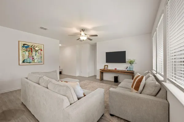 a living room with furniture and a flat screen tv