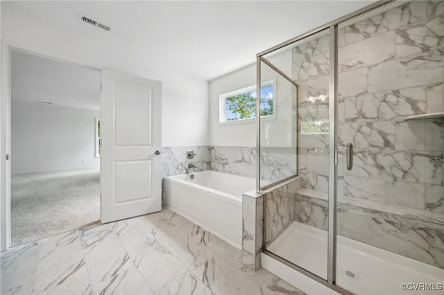 a bathroom with a bathtub and a shower