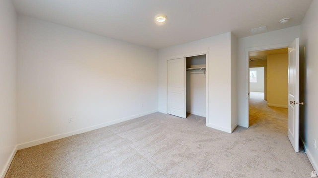 777 Pheasantbrook Drive, Unit 2B Centerville, UT 84014 - Photo 24 of 42 Carpeted room featuring white walls, a flush-mount ceiling light, and a bi-fold closet with an interior rod