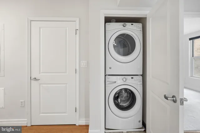 a view of a hallway with washer and dryer