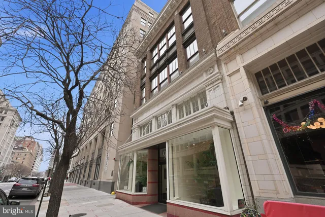 a view of a building with a large tree