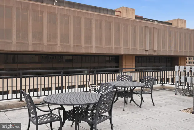 a balcony with table and chairs