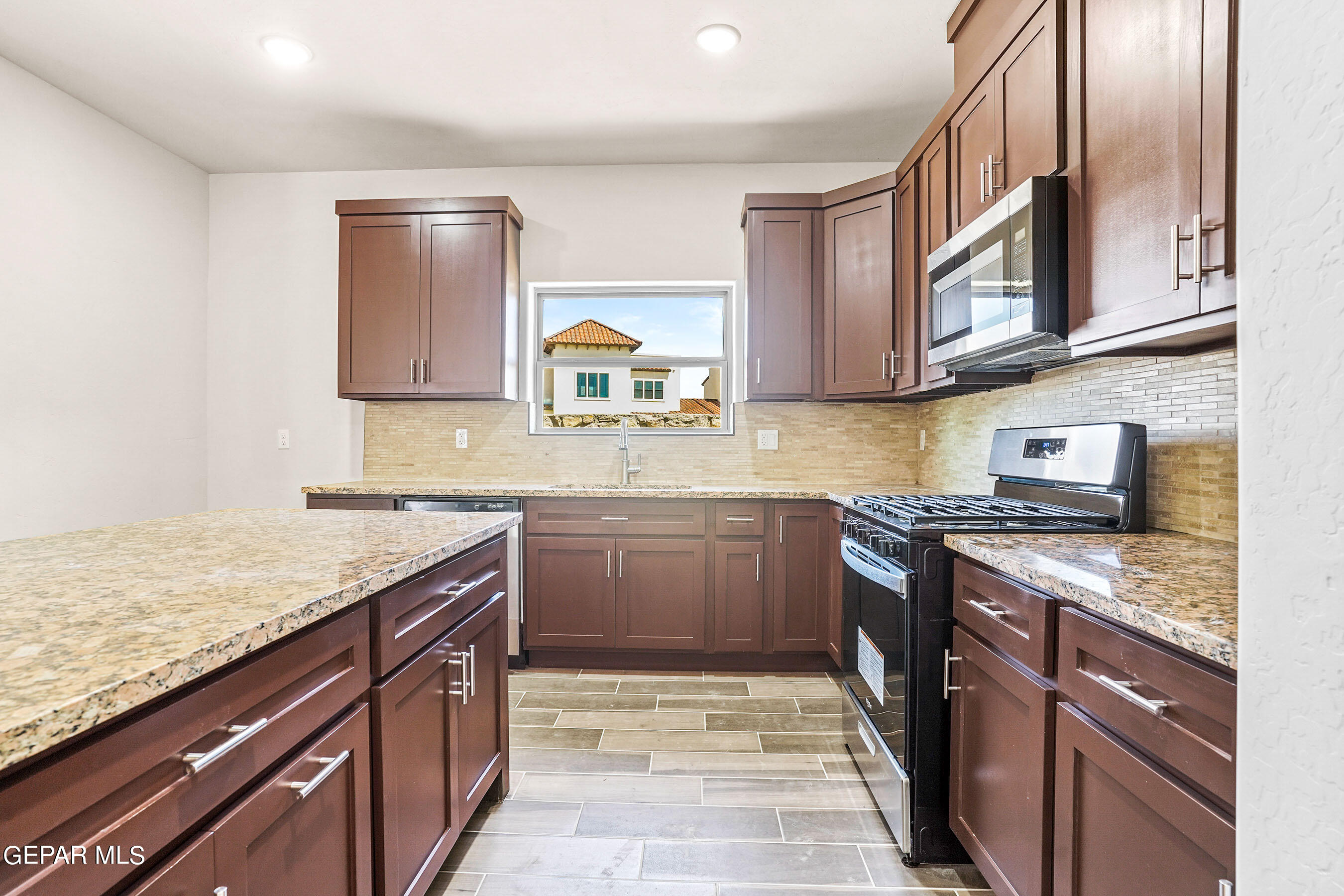 871 Country Club Road, Unit 4E El Paso, TX 79932 - Photo 2 of 34 a kitchen with stainless steel appliances granite countertop a sink stove and cabinets