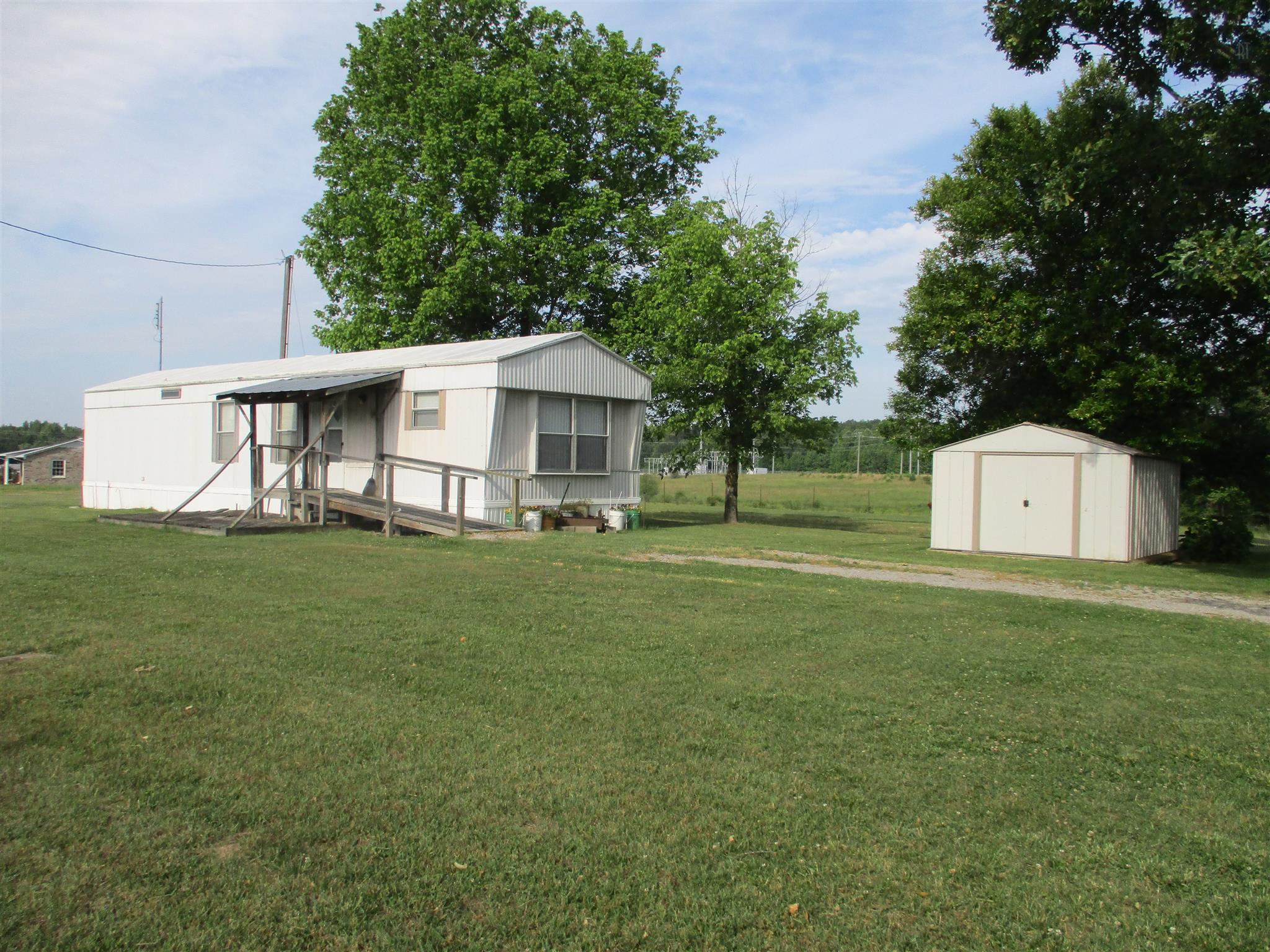 29 Owens Road Five Points, TN 38457 - Photo 3 of 26 a front view of a house with a garden and trees