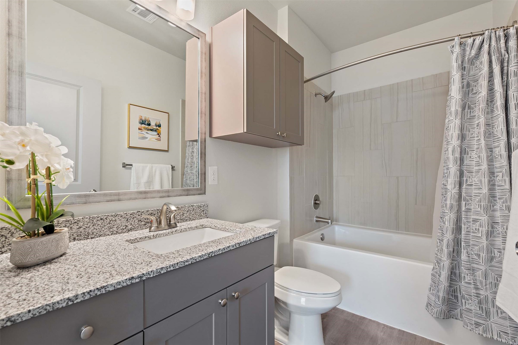 1101 Halsey Drive, Unit 818 Leander, TX 78641 - Photo 47 of 50 a bathroom with a granite countertop sink toilet and shower