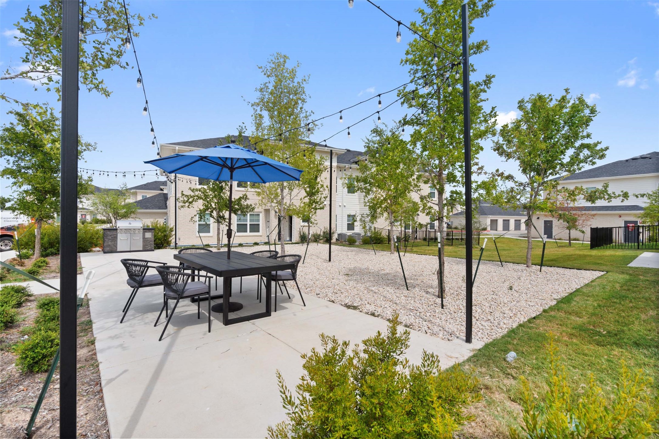 1101 Halsey Drive, Unit 818 Leander, TX 78641 - Photo 7 of 50 a view of a tables and chairs under an umbrella