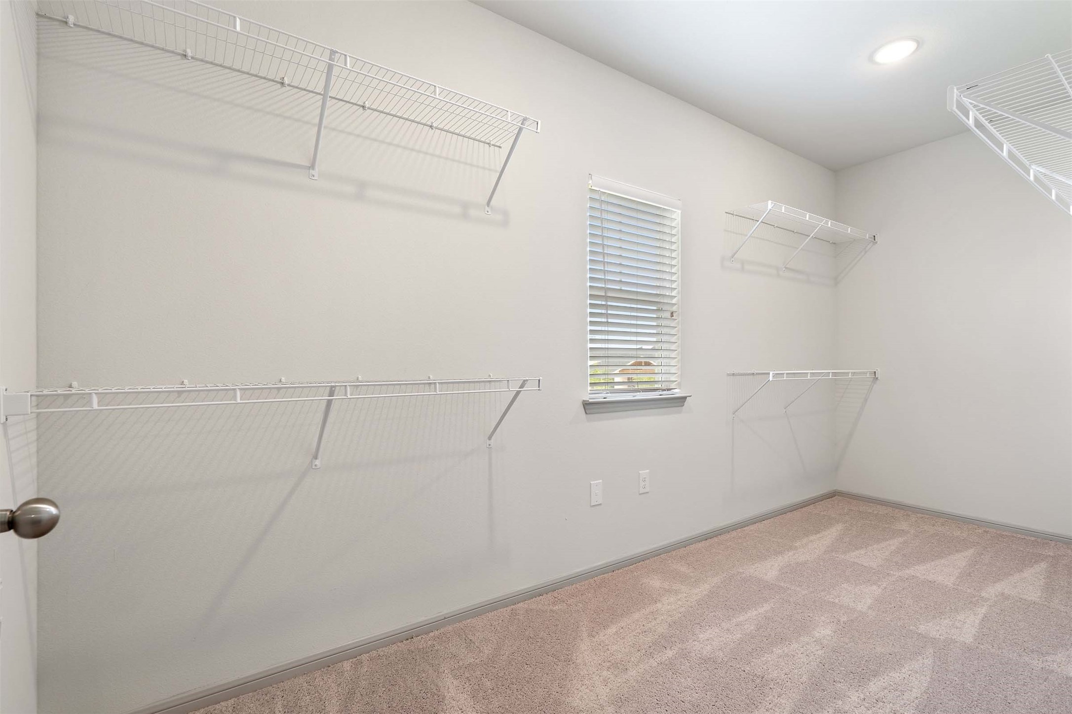 1101 Halsey Drive, Unit 818 Leander, TX 78641 - Photo 16 of 50 a view of a room with racks on the wall