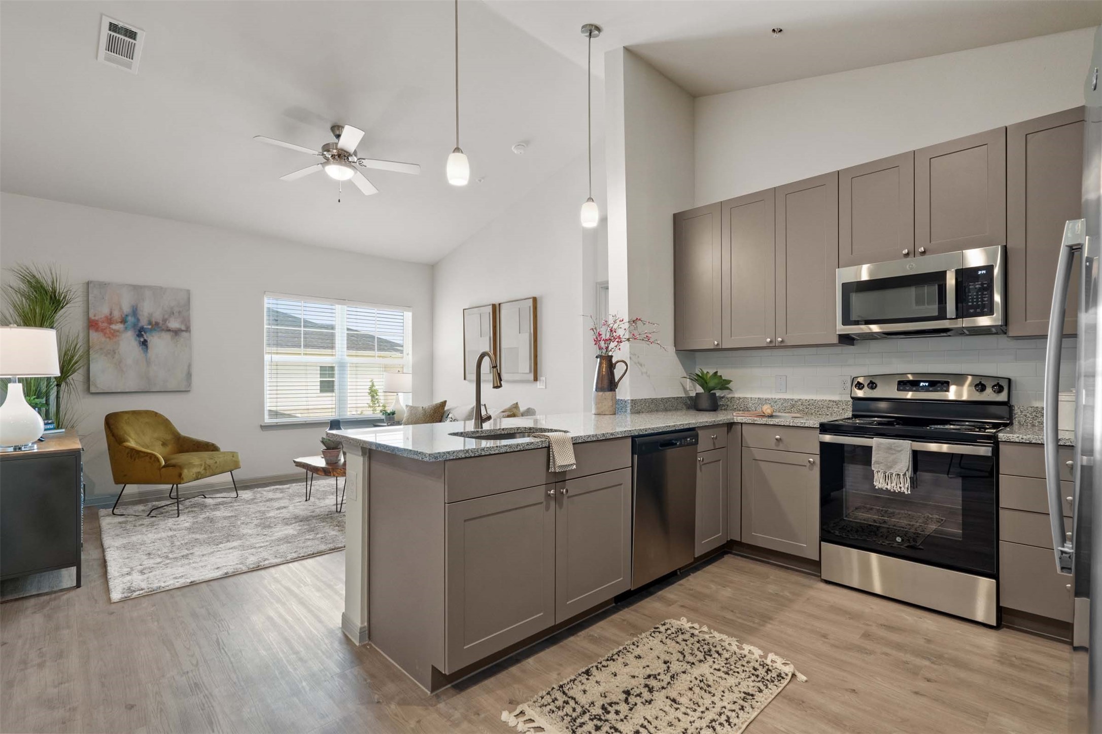 1101 Halsey Drive, Unit 818 Leander, TX 78641 - Photo 36 of 50 a kitchen with stainless steel appliances granite countertop a stove top oven a sink dishwasher a dining table and chairs with wooden floor
