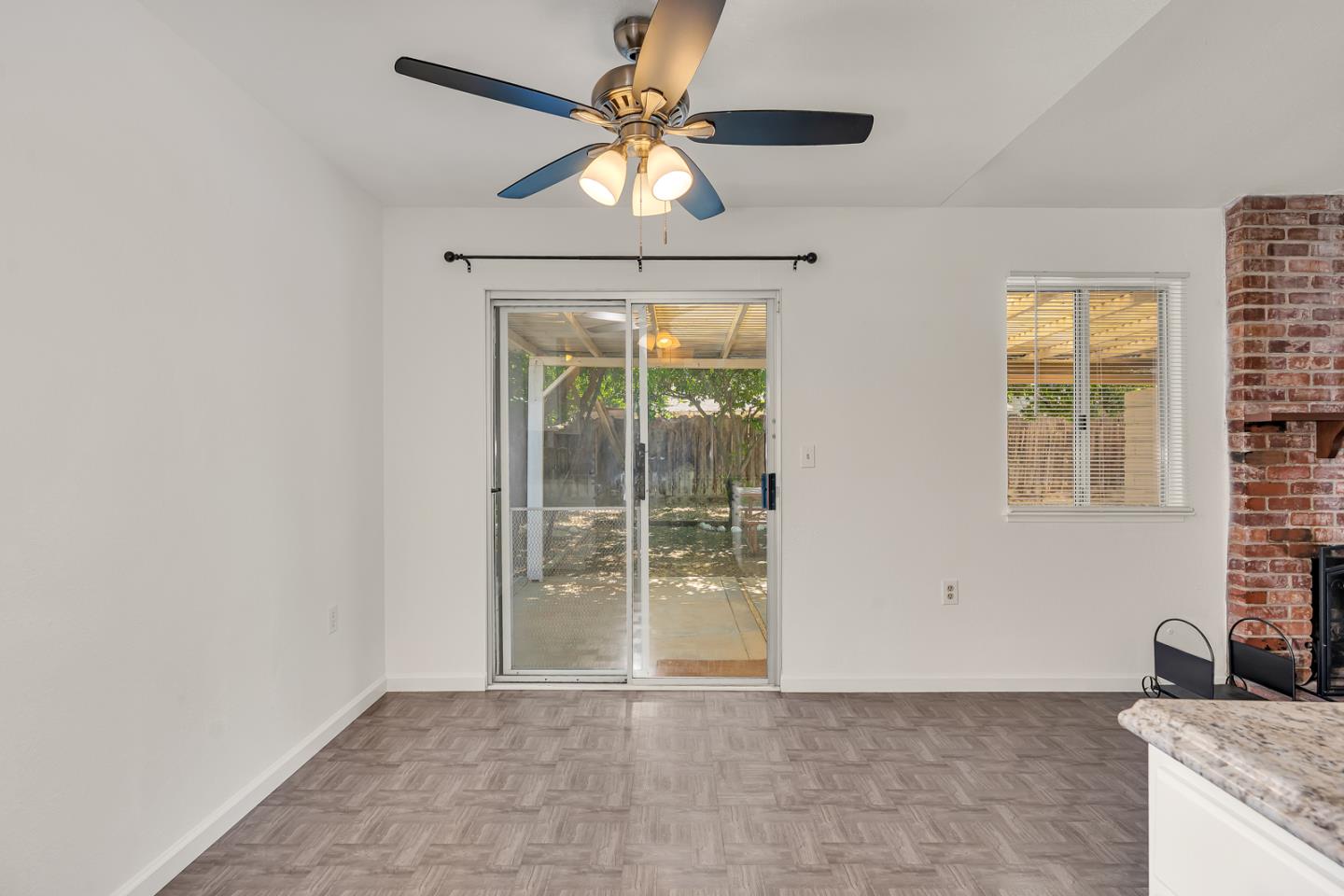 1351 Chukar Street Los Banos, CA 93635 - Photo 13 of 34 a view of a livingroom with a ceiling fan and a window