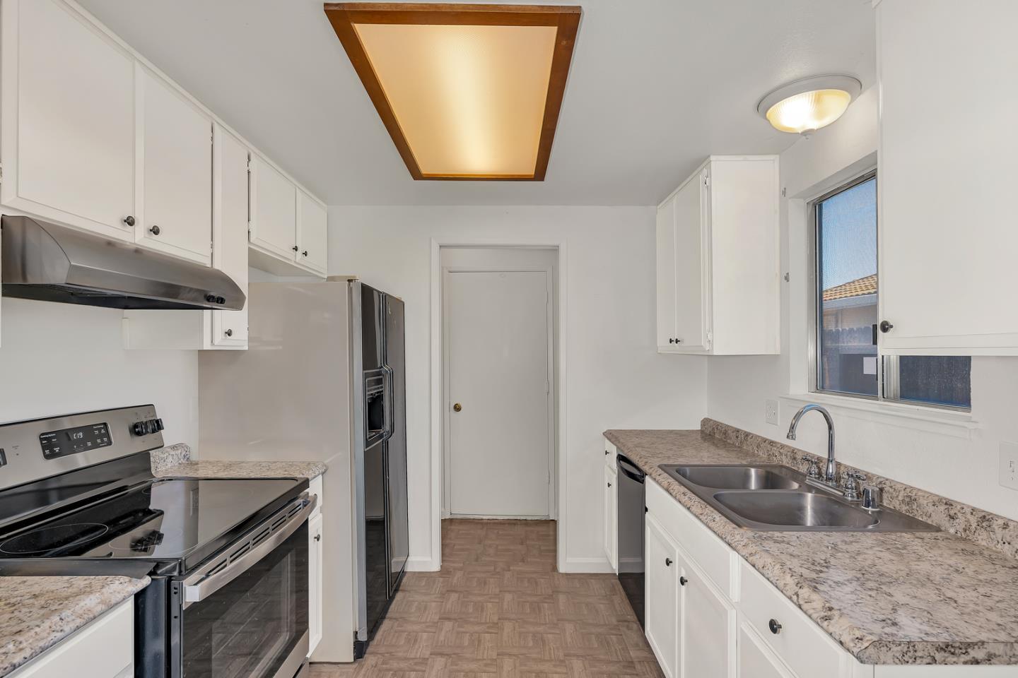 1351 Chukar Street Los Banos, CA 93635 - Photo 15 of 34 a kitchen with stainless steel appliances granite countertop a sink stove and refrigerator