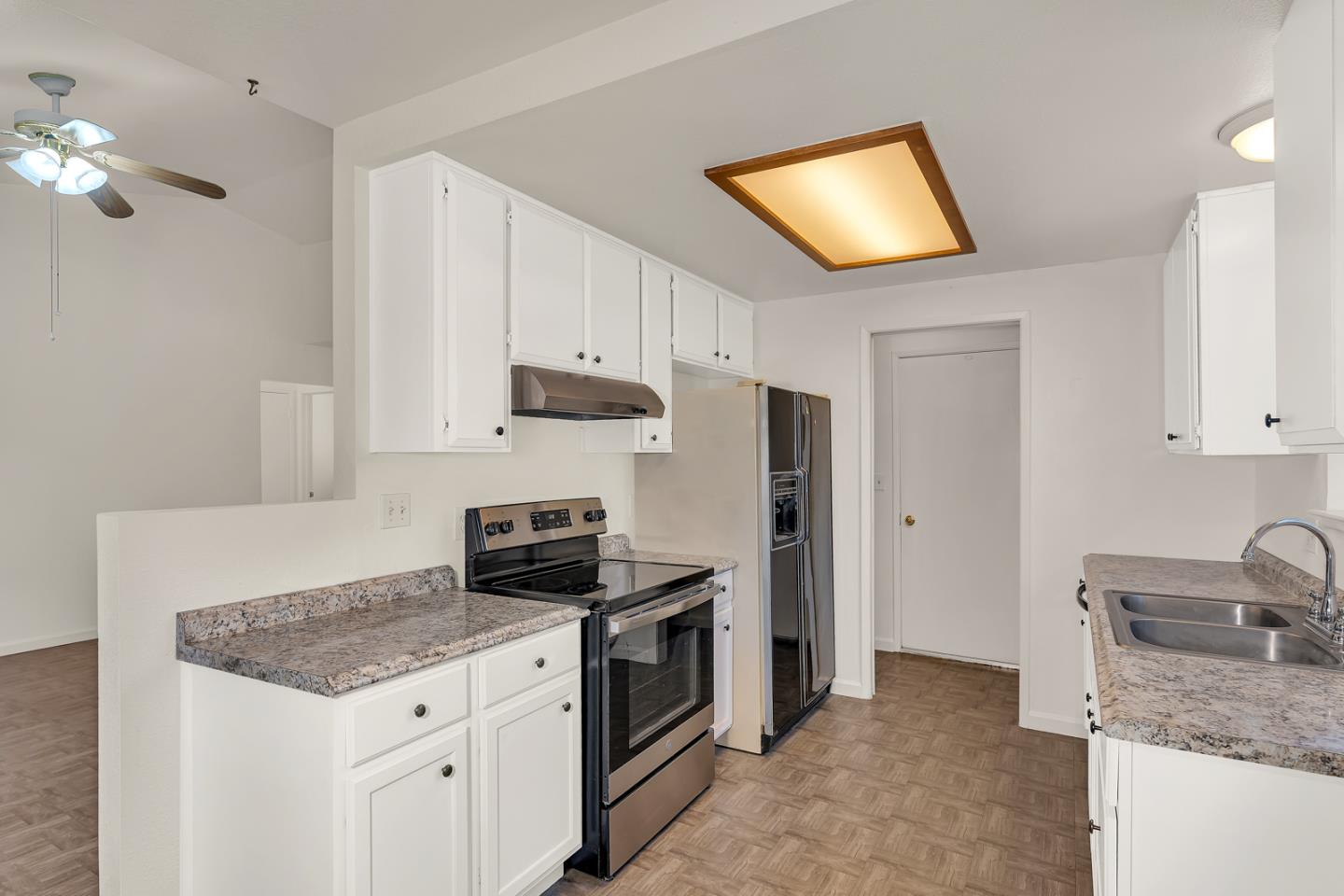 1351 Chukar Street Los Banos, CA 93635 - Photo 16 of 34 a kitchen with granite countertop a sink stove and refrigerator