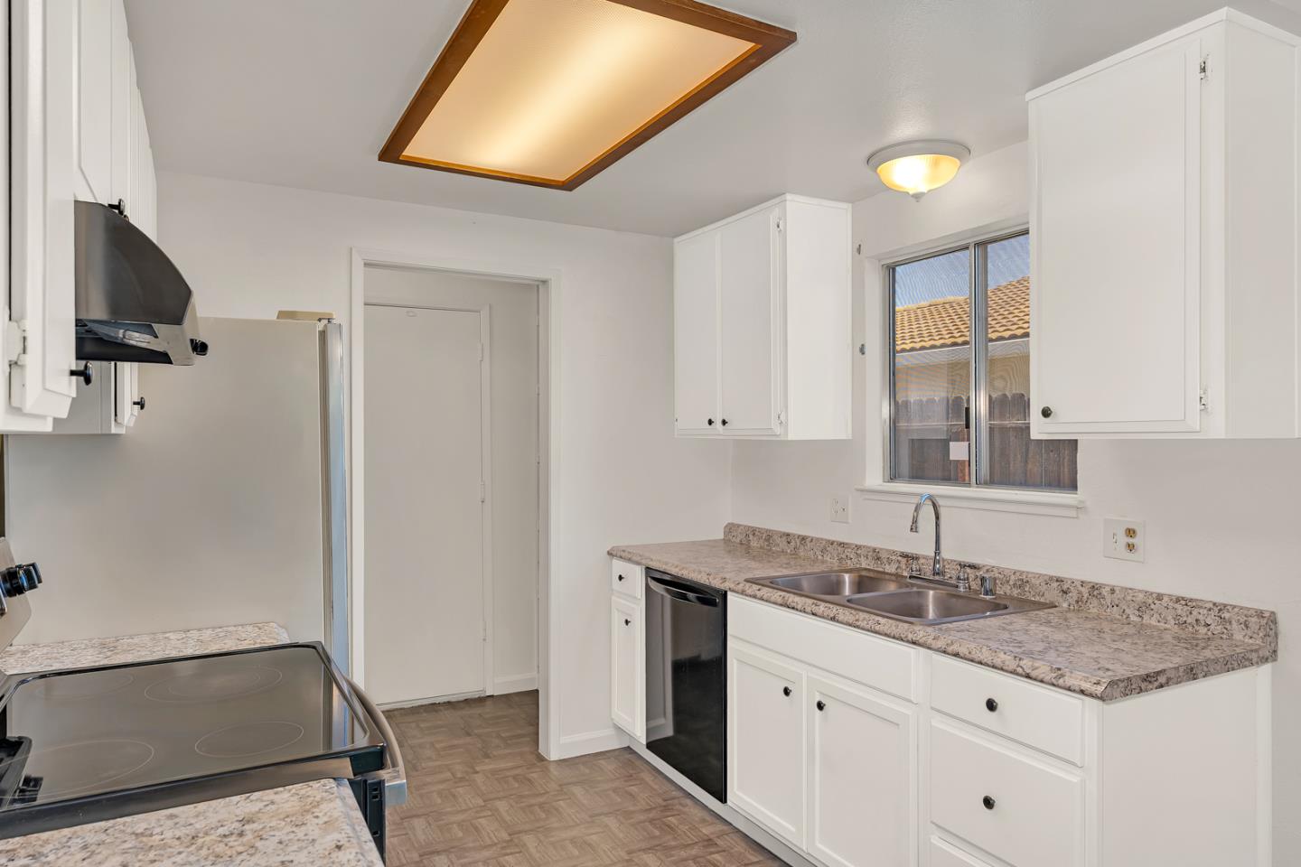 1351 Chukar Street Los Banos, CA 93635 - Photo 17 of 34 a kitchen with a sink cabinets and window