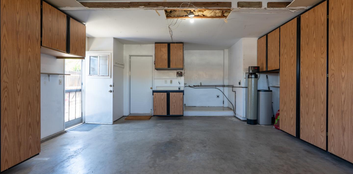 1351 Chukar Street Los Banos, CA 93635 - Photo 23 of 34 a view of kitchen with stainless steel appliances kitchen island empty room and wooden floor
