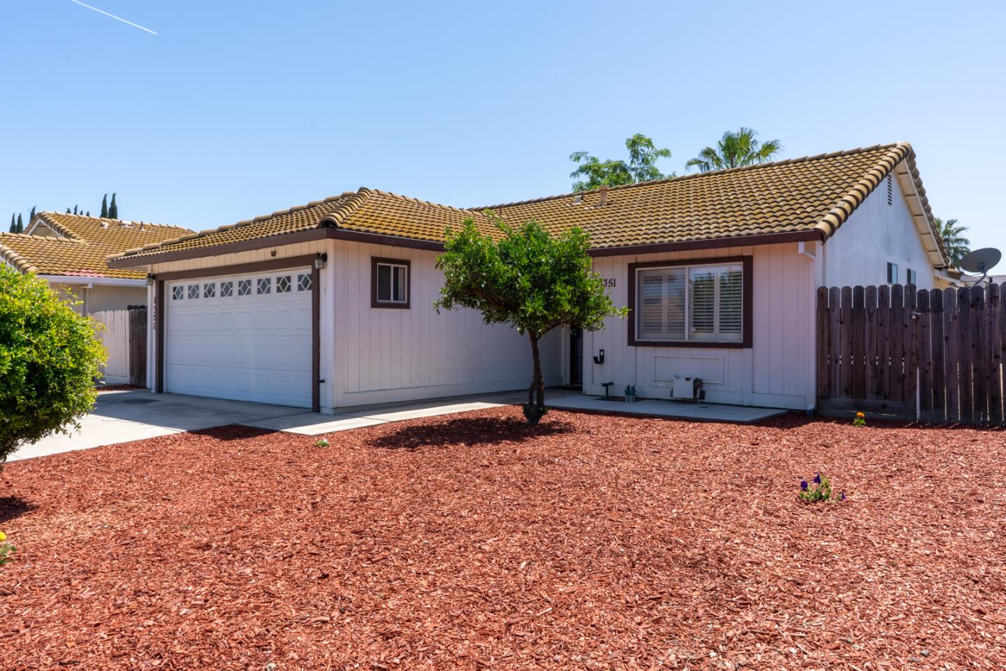 1351 Chukar Street Los Banos, CA 93635 - Photo 3 of 34 a front view of a house with a yard and garage