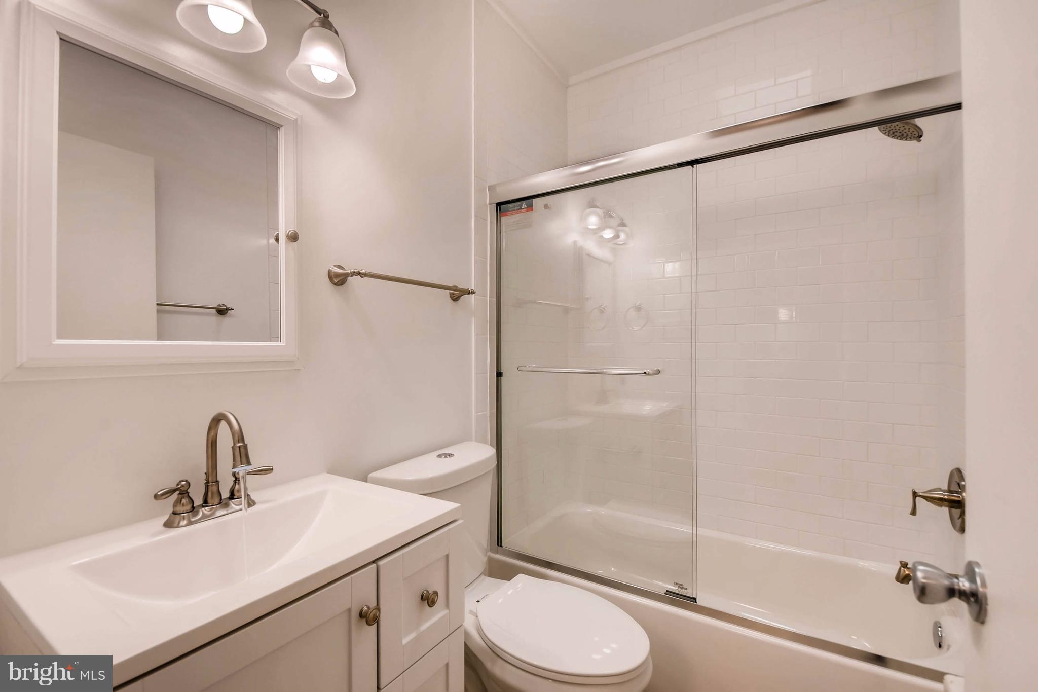 843 North Howard Street, Unit 2 Baltimore, MD 21201 - Photo 9 of 16 a bathroom with a sink toilet and shower