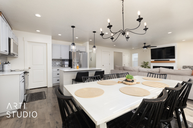 1713 South Windemere Road Santaquin, UT 84655 - Photo 9 of 40 Open-concept living space with wood-finish flooring, recessed lighting, and a white dining table