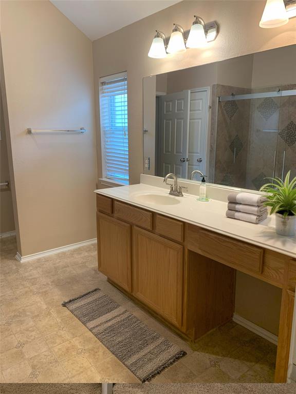 3313 Timber Ridge Trail McKinney, TX 75071 - Photo 10 of 20 Bathroom with baseboards, vanity, and a stall shower