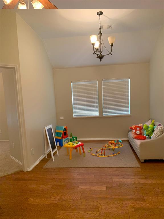 3313 Timber Ridge Trail McKinney, TX 75071 - Photo 13 of 20 Rec room with vaulted ceiling, wood finished floors, visible vents, and baseboards