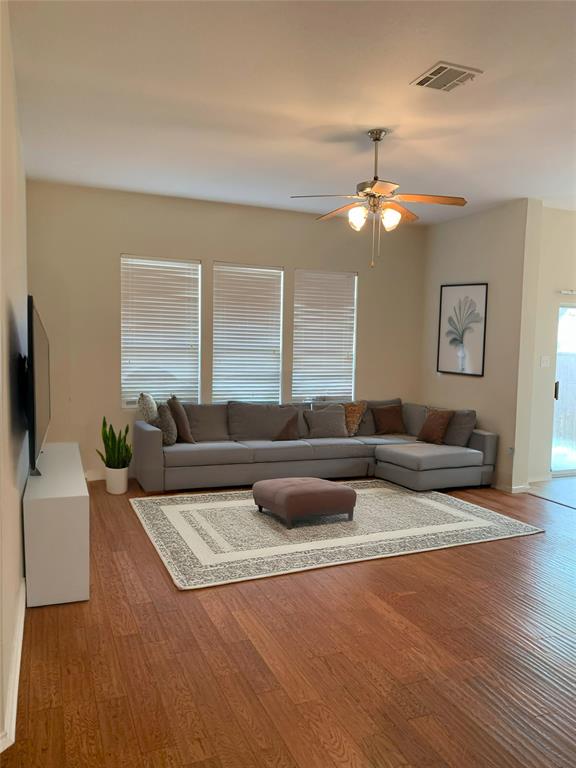 3313 Timber Ridge Trail McKinney, TX 75071 - Photo 5 of 20 Living room with light wood-style flooring, visible vents, and a ceiling fan