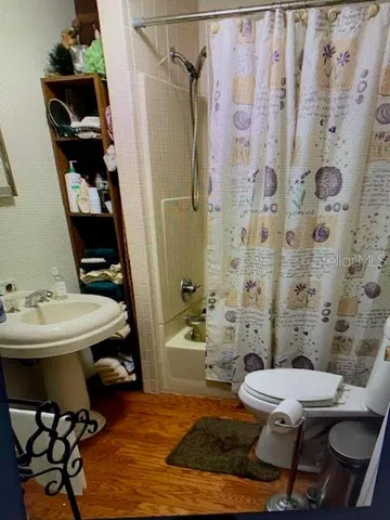 a bathroom with a sink toilet and shower