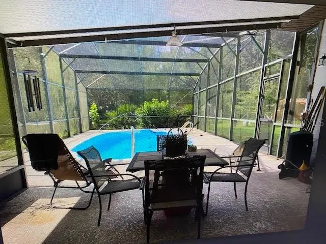 a view of balcony with furniture and umbrella