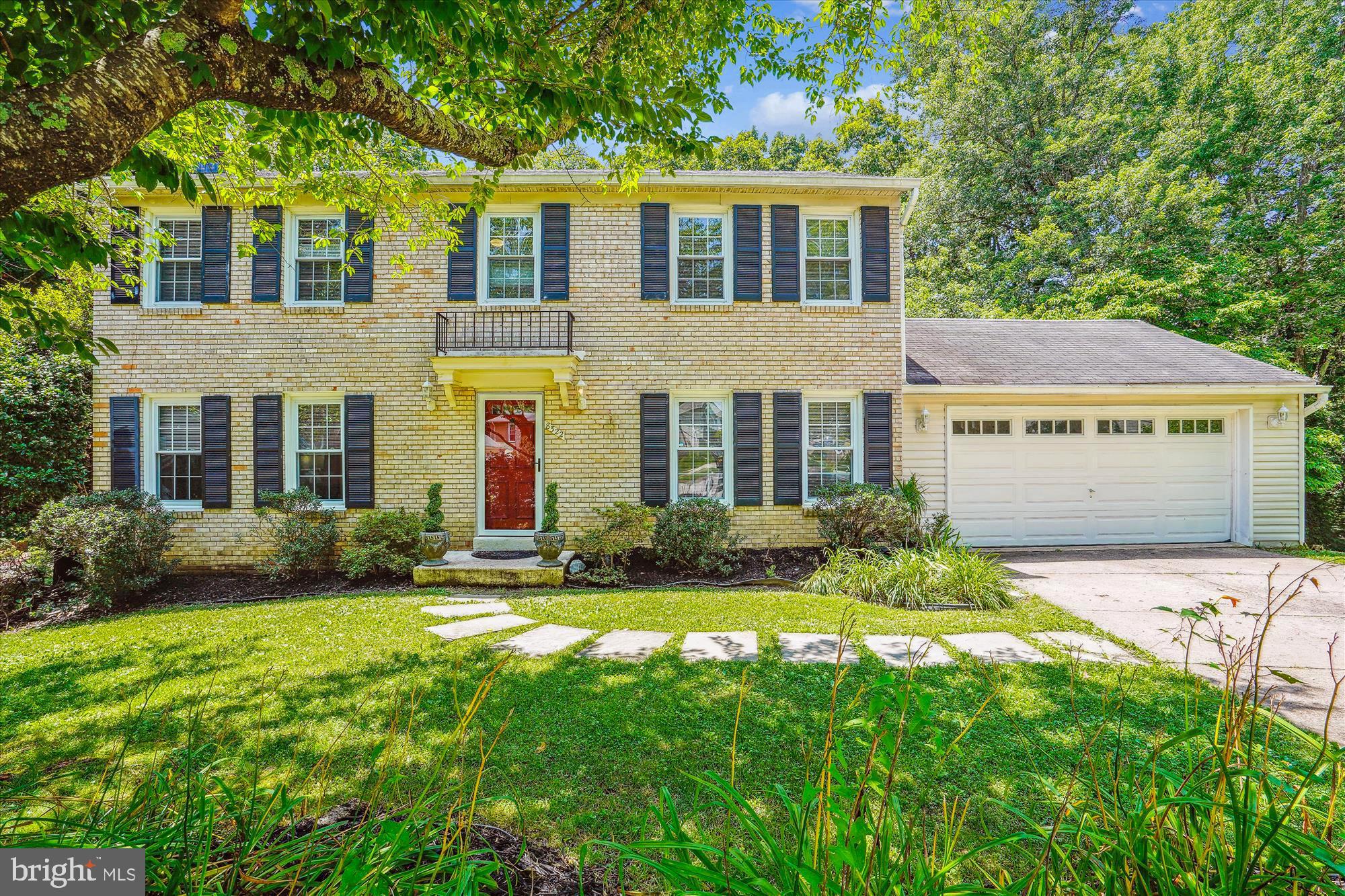 a view of house with yard and green space