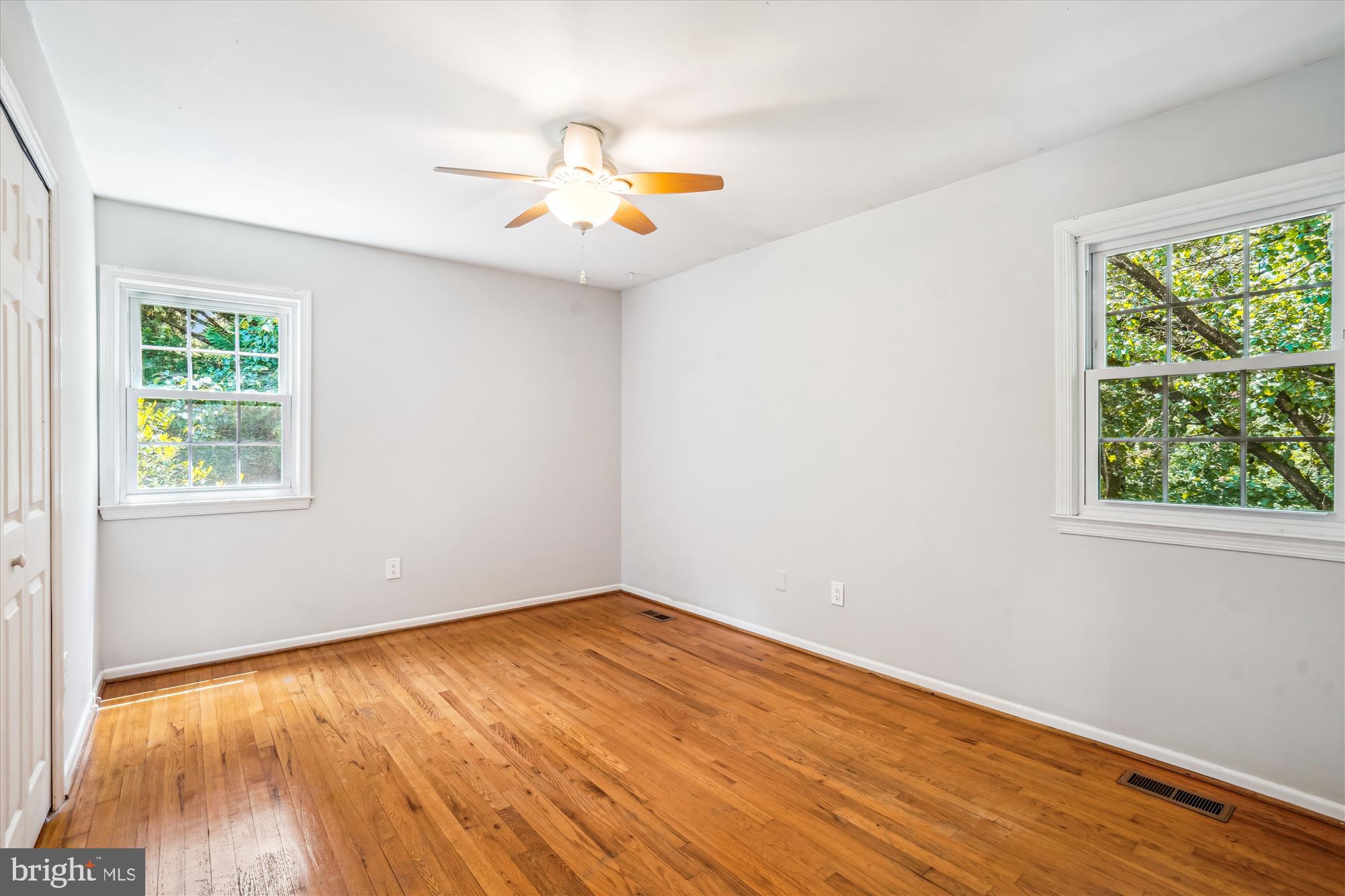 8322 Cushing Court Springfield, VA 22153 - Photo 20 of 57 a view of an empty room with wooden floor and a window