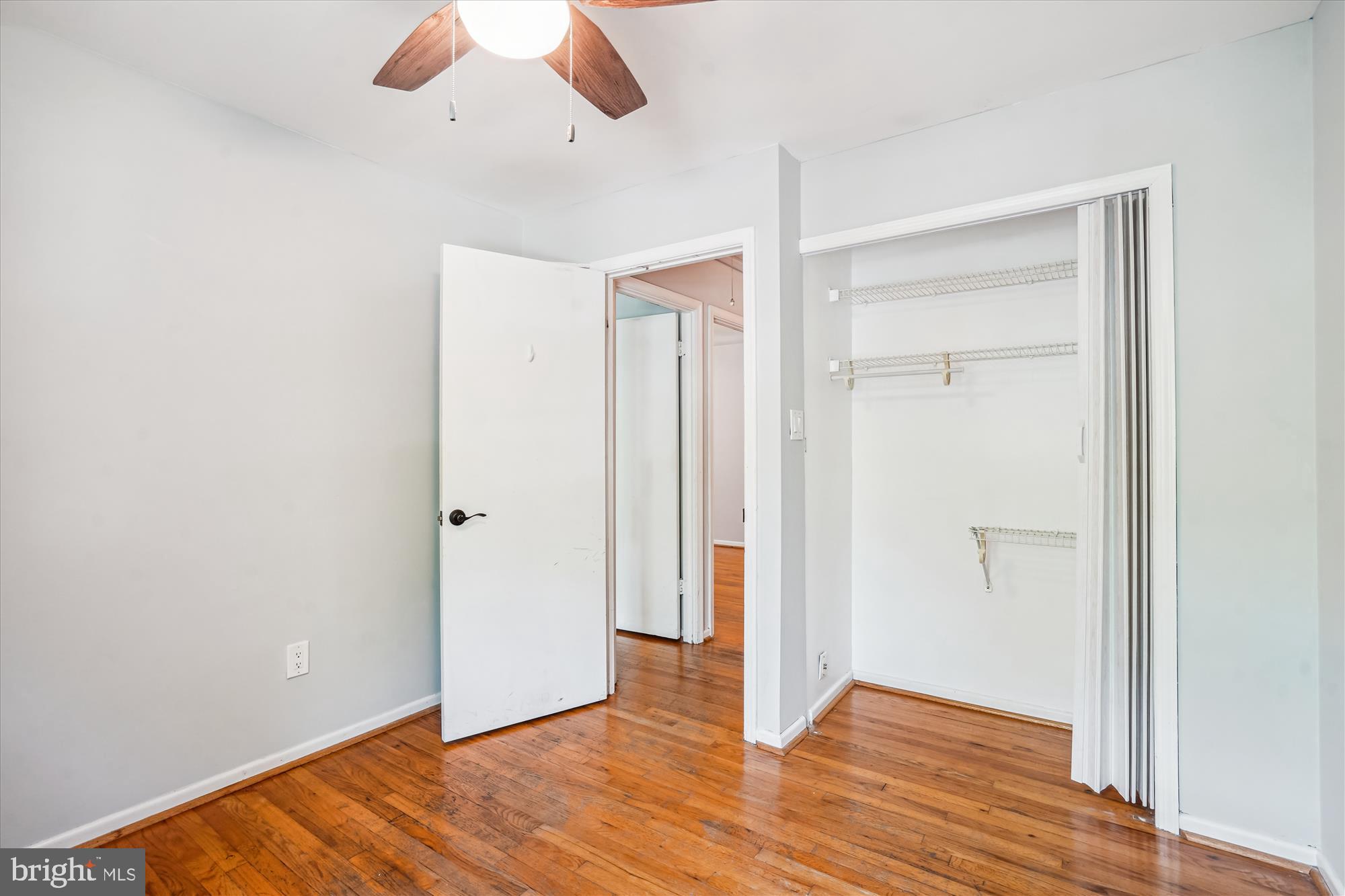 8322 Cushing Court Springfield, VA 22153 - Photo 25 of 57 an empty room with wooden floor and closet