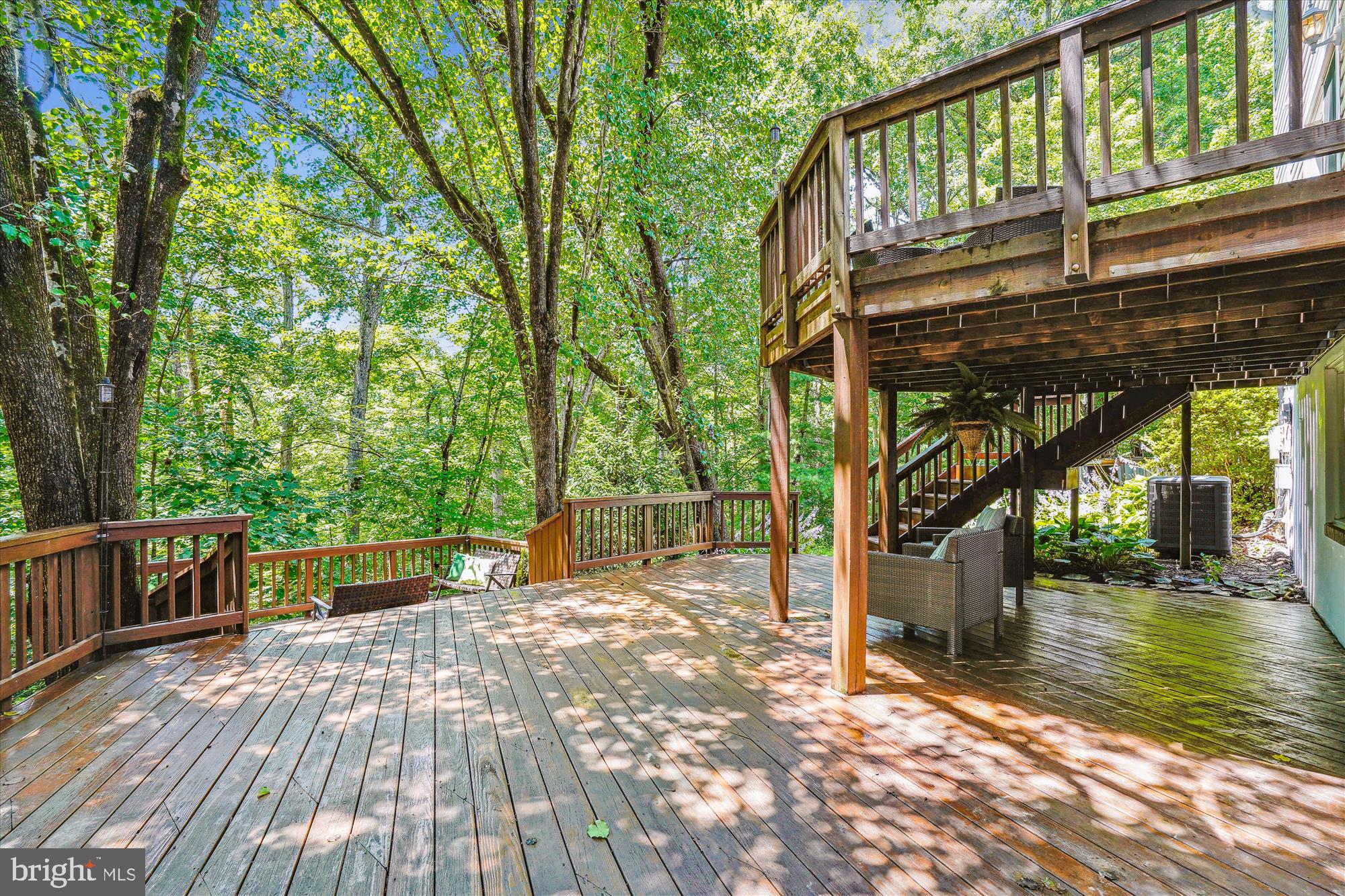 8322 Cushing Court Springfield, VA 22153 - Photo 37 of 57 a view of a patio with table and chairs and wooden floor
