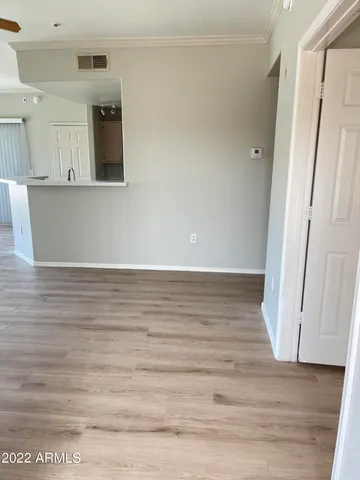 a view of a kitchen with wooden floor and staircase