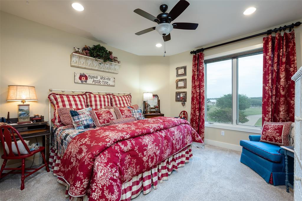 2312 Cactus Rio Lane Weatherford, TX 76087 - Photo 29 of 37 a bedroom with a bed and a chandelier
