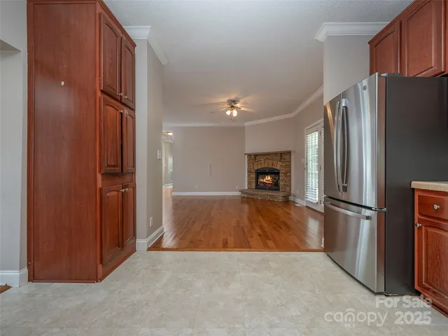 a view of kitchen with furniture and refrigerator
