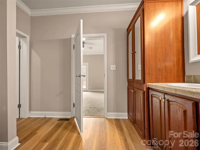 a view of bathroom with a sink and mirror