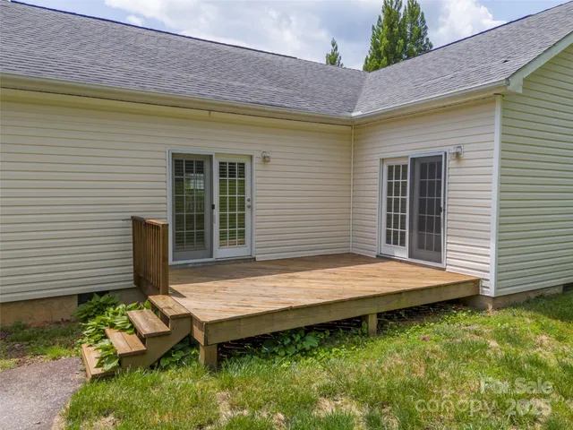 a wooden bench sitting in front of a house