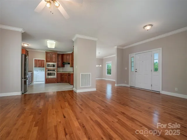 a view of a kitchen with a sink and a refrigerator